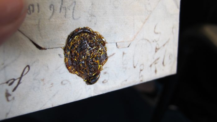 Old fashioned wax seal with gold flakes